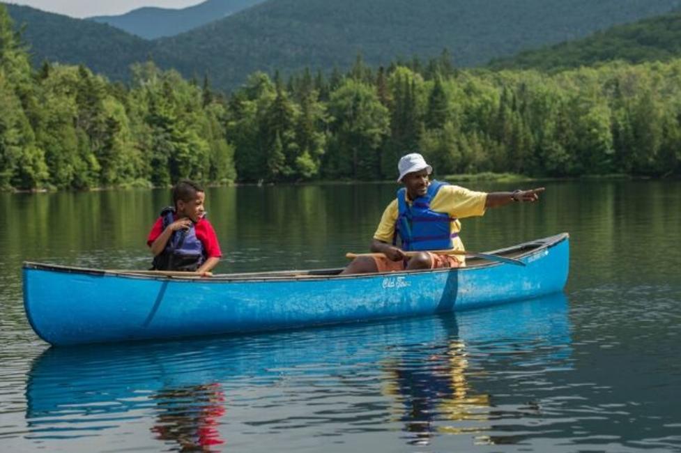 Canoeing in the Adirondacks A boy and a man canoe on Heart Lake in the Adirondacks