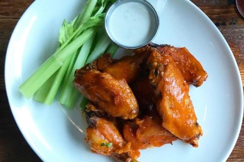 Buffalo Wings A plate of Buffalo wings with celery and blue cheese sauce