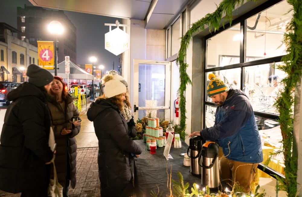 Midnight madness, blom pours drink for guest