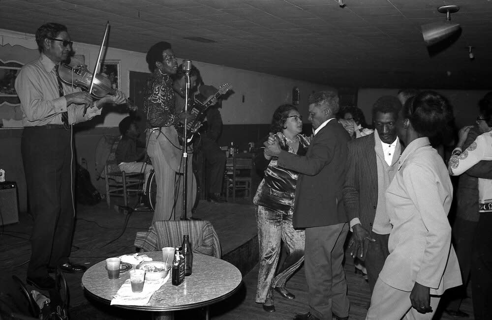 Calvin Carrière, fiddle; Delton Broussard, accordion. The Lawtell Playboys at Slim’s on a Saturday night. Probably at the same show advertised above.