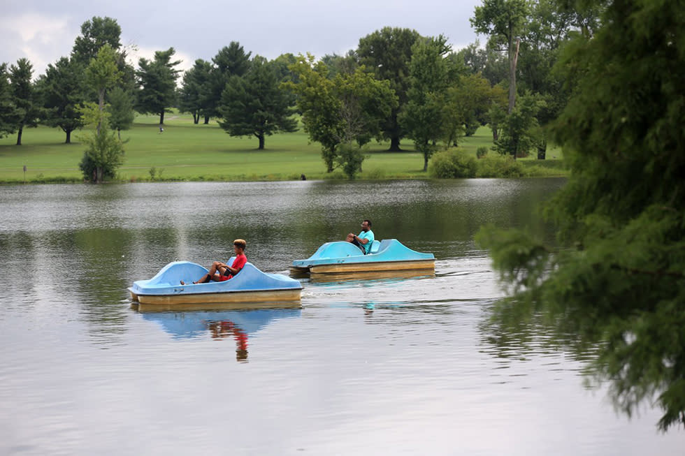 Two people enjoying a paddle boat ride on a lake