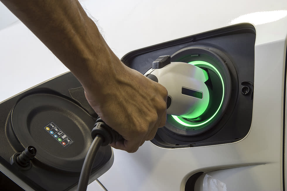 man charging electronic vehicle