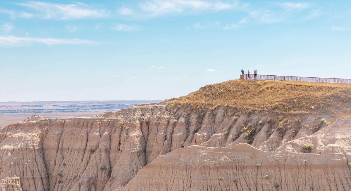 Overlook with visitors taking in the view in badlands national park near rapid city, south dakota