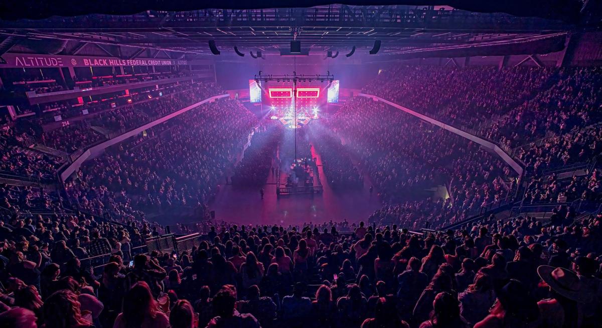 concert crowd with purple lighting and full stadium at the monument in rapid city south dakota