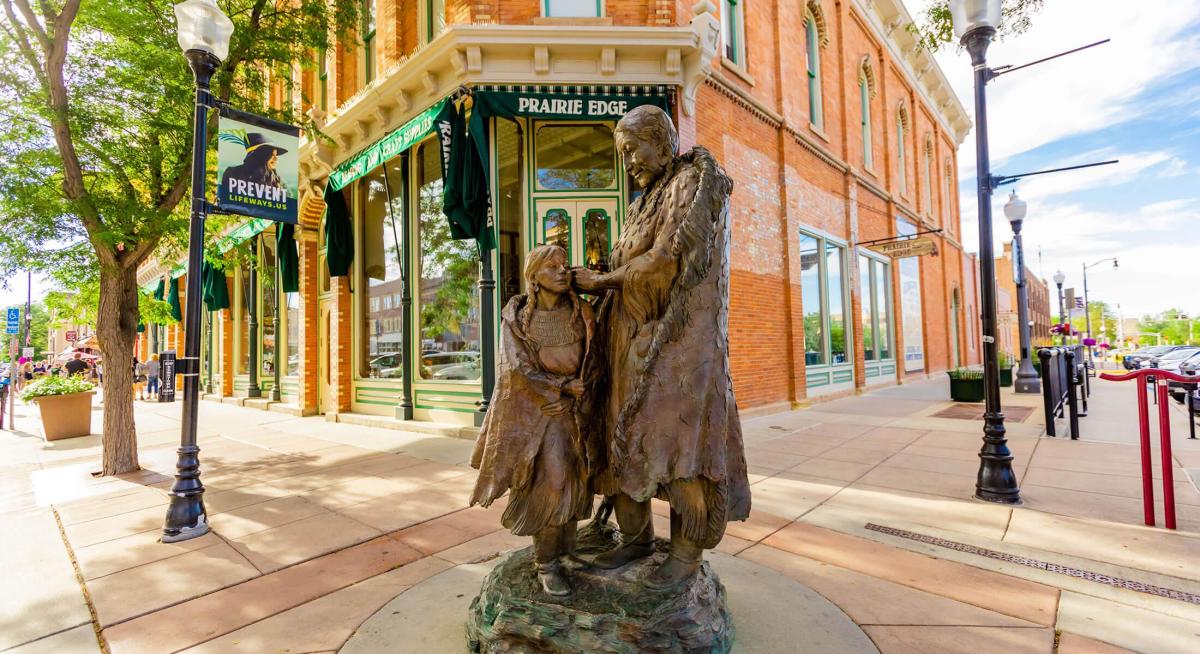 Exterior of Prairie Edge Trading Company with statue in downtown Rapid City, SD