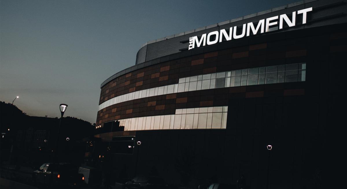 The Monument signage lit up on the exterior of the summit arena in rapid city south dakota