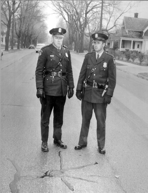 two officers standing at the sputnik marker