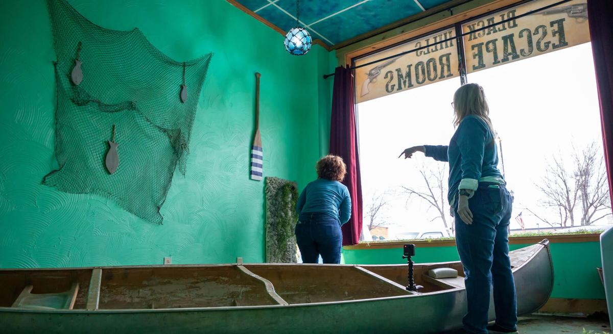 Team working to solve the Black Hills Escape Roomed themed after lake pactola