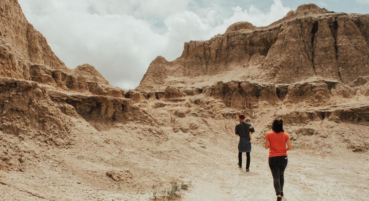 Family hiking through Badlands National Park in SD