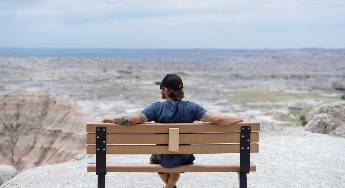 Visitor sitting on bench at one of the overlooks in Badlands National Park