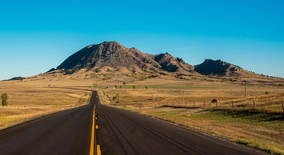 the road to bear butte state park with the mountain in the distance found in south dakota