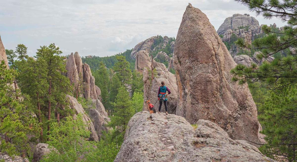 Rock climber and dog in the Black Hills National Forest