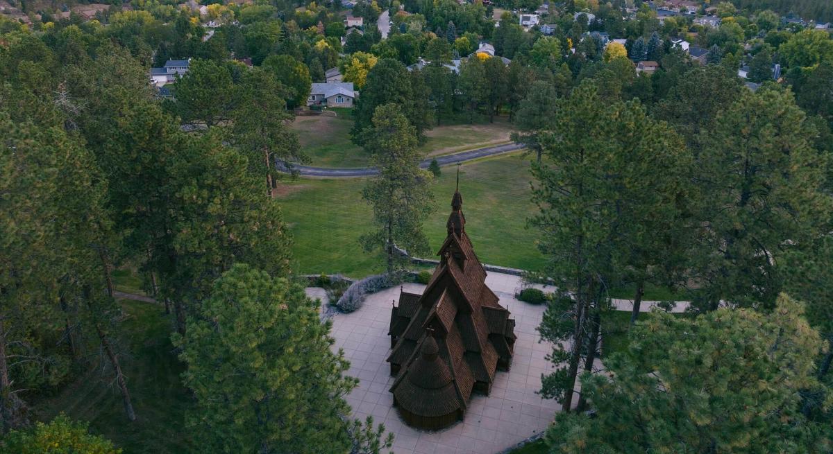 Drone image of behind the wooden chapel in the hills in rapid city, south dakota