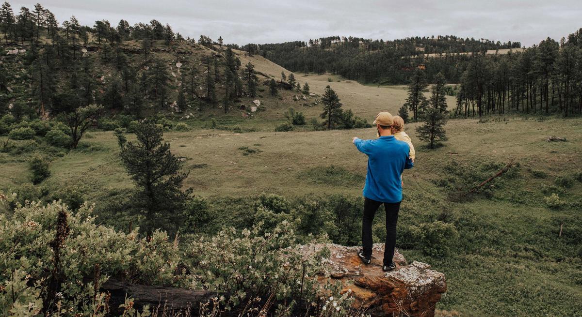 Father and daughter enjoying scenic overlook in Custer State Park