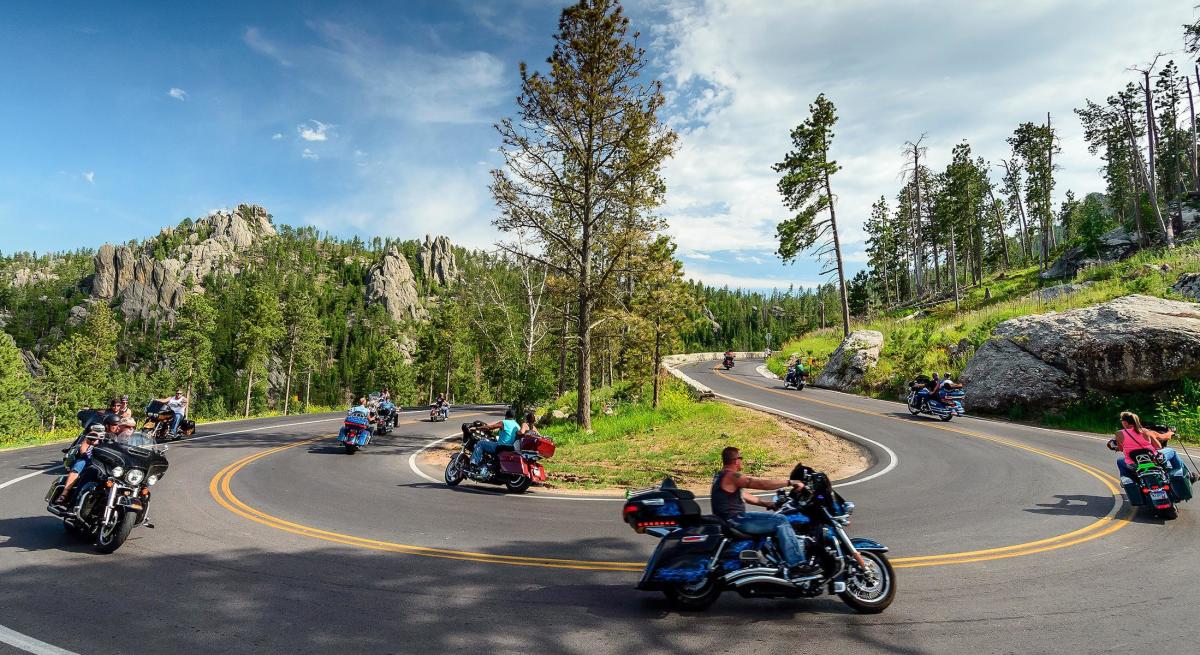 motorcycles taking the turns of needles highway in custer state park
