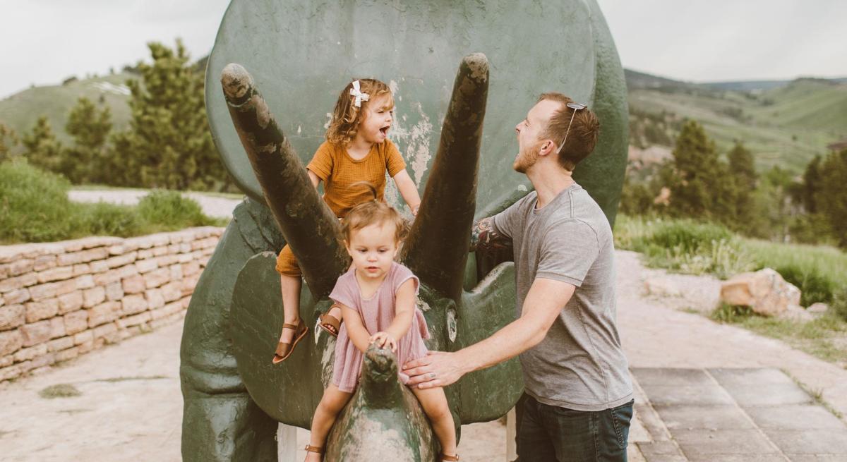 Father and daughters playing at Dinosaur Park in Rapid City, SD