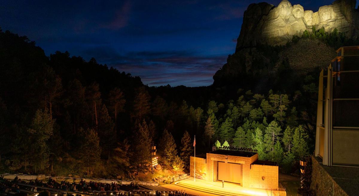 Amphitheater with illuminated mount rushmore during the Evening Lighting Ceremony