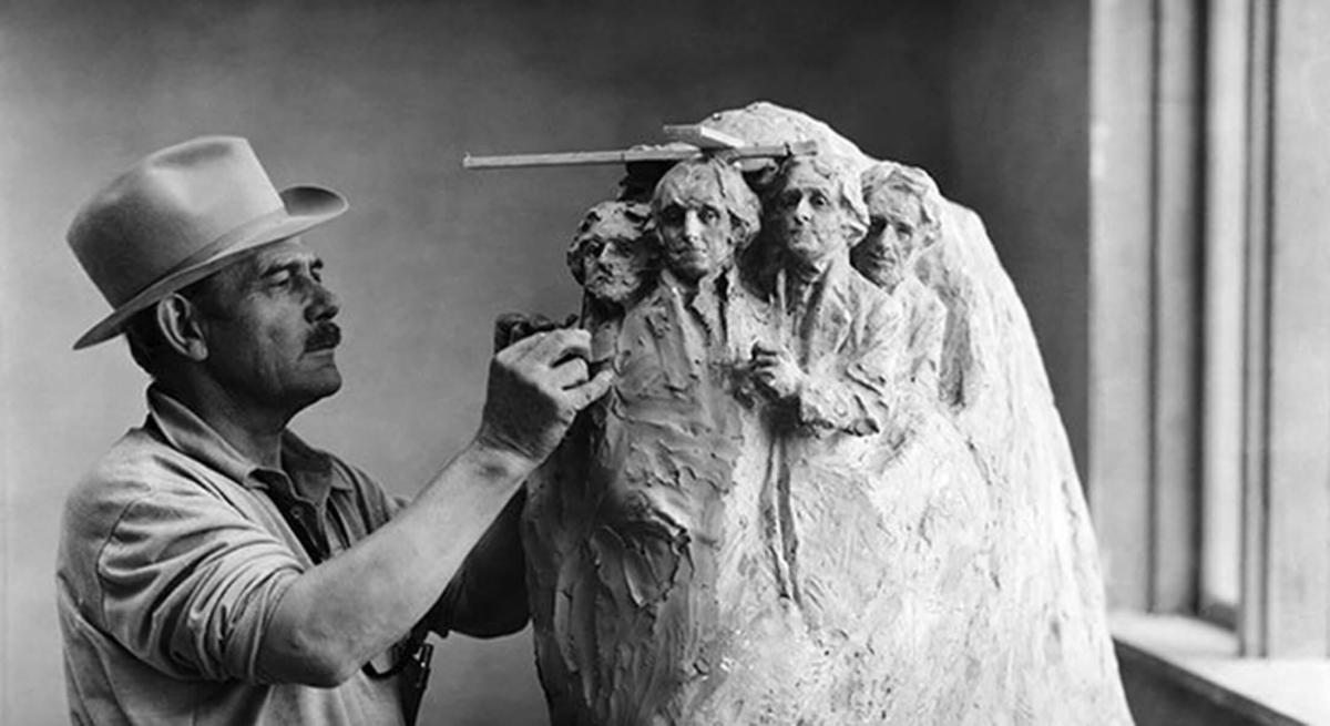 Gutzon Borglum carving a model of Mount Rushmore