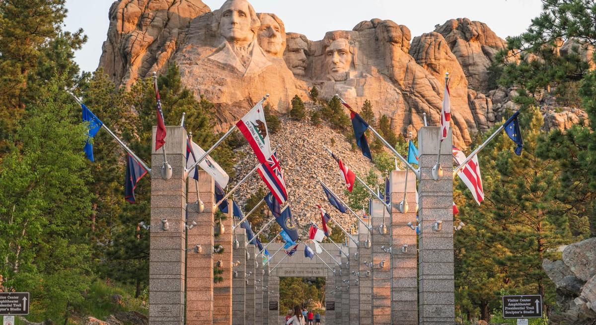Larger flag poles and narrow walk way of the old Avenue of Flags at Mount Rushmore