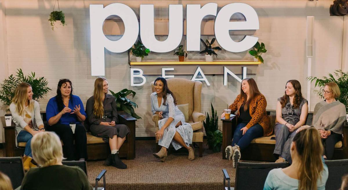 Speakers on the stage in the pure bean coffee house event space