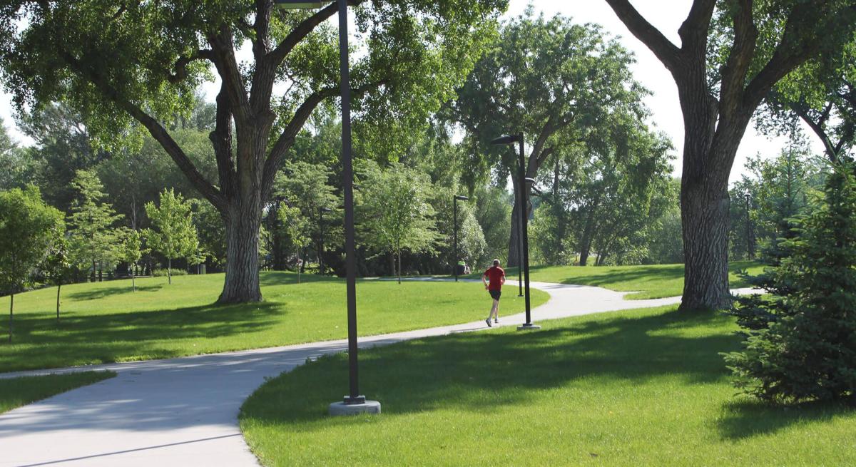 Runner enjoying the green space that surrounds the Rapid City Bike Path