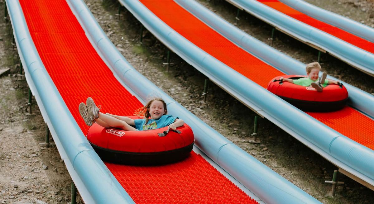 Kids enjoying the tubing hill at rushmore tramway adventures