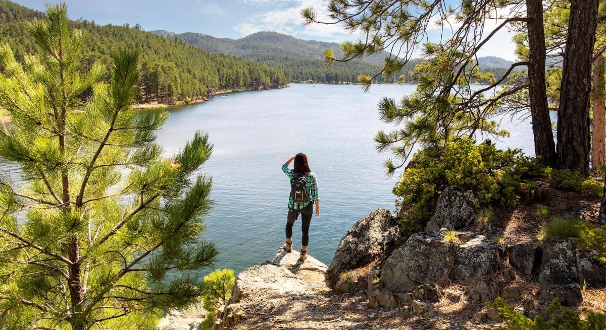 hiker enjoying the overlook from the centennial trail in south dakota at sheridan lake in the black hills