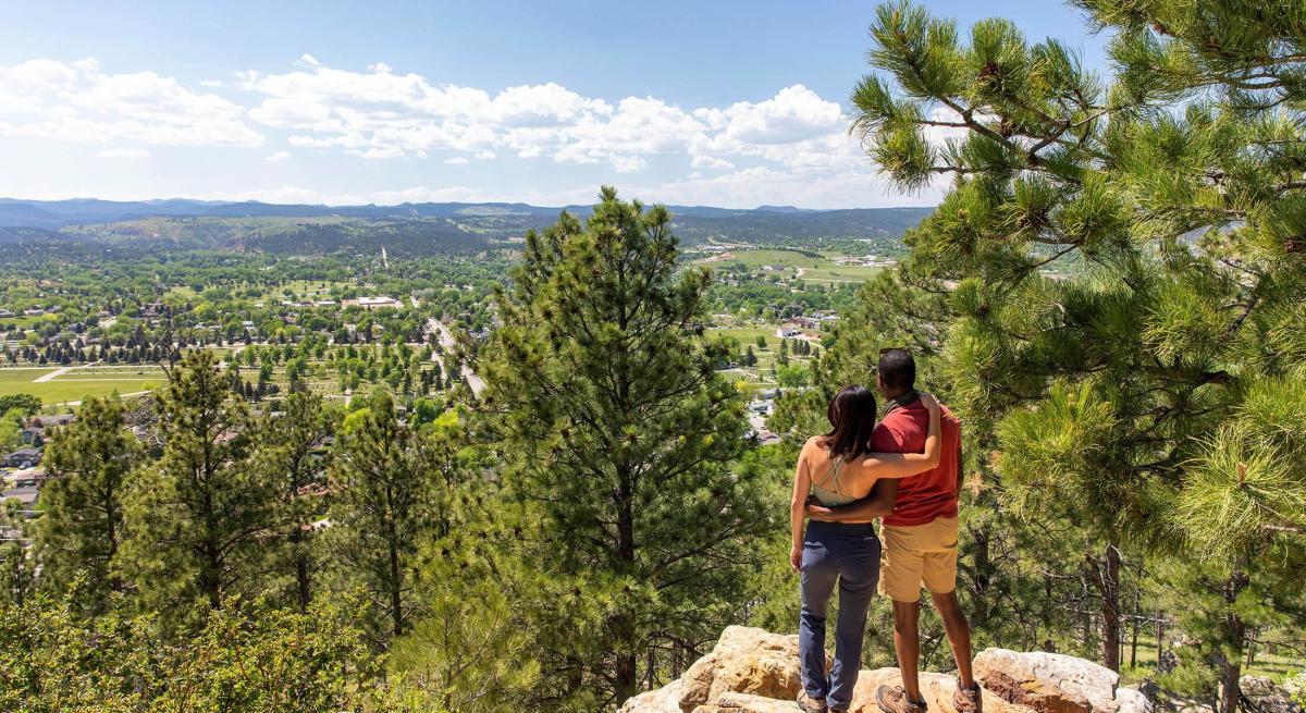 Hikers enjoying the scenic overlook of rapid city from the trails of skyline wilderness area