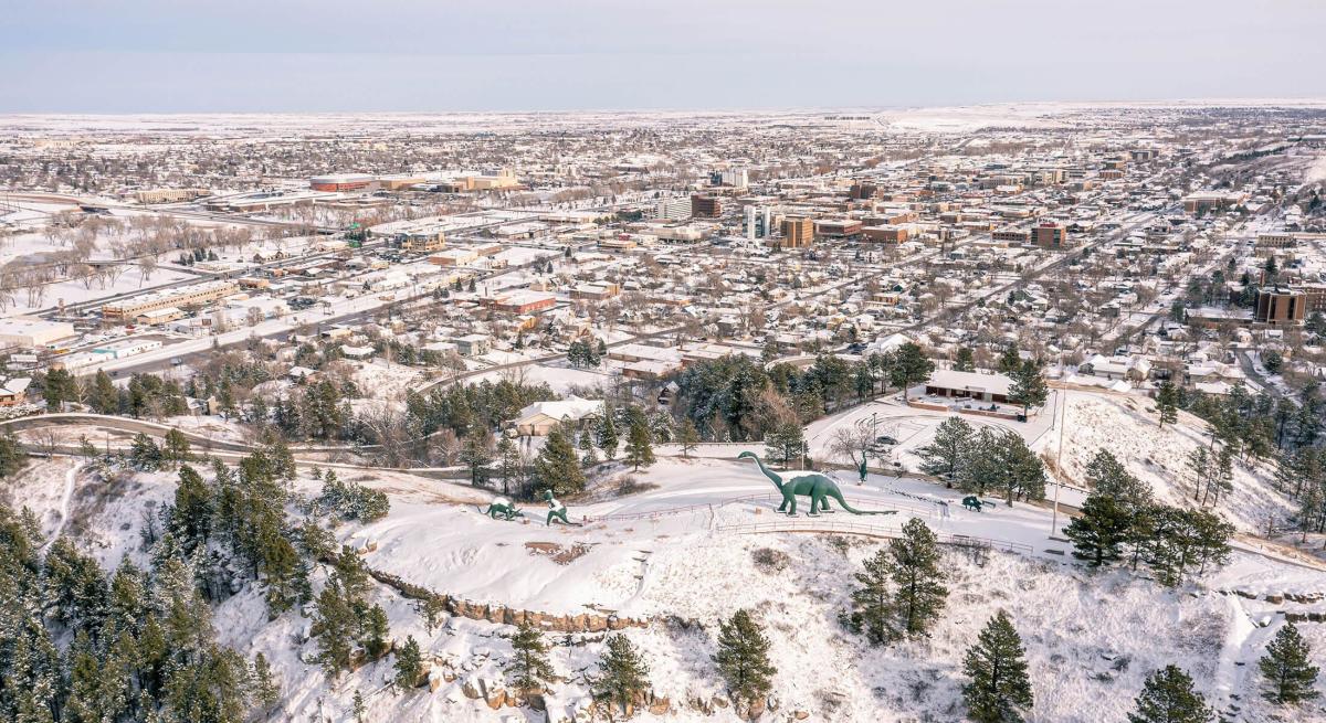 Snowy drone view of Dinosaur Park overlooking Downtown Rapid City