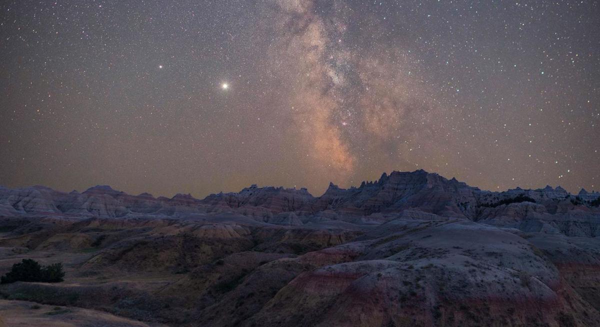 Starry night over the eroded buttes of Badlands National Park