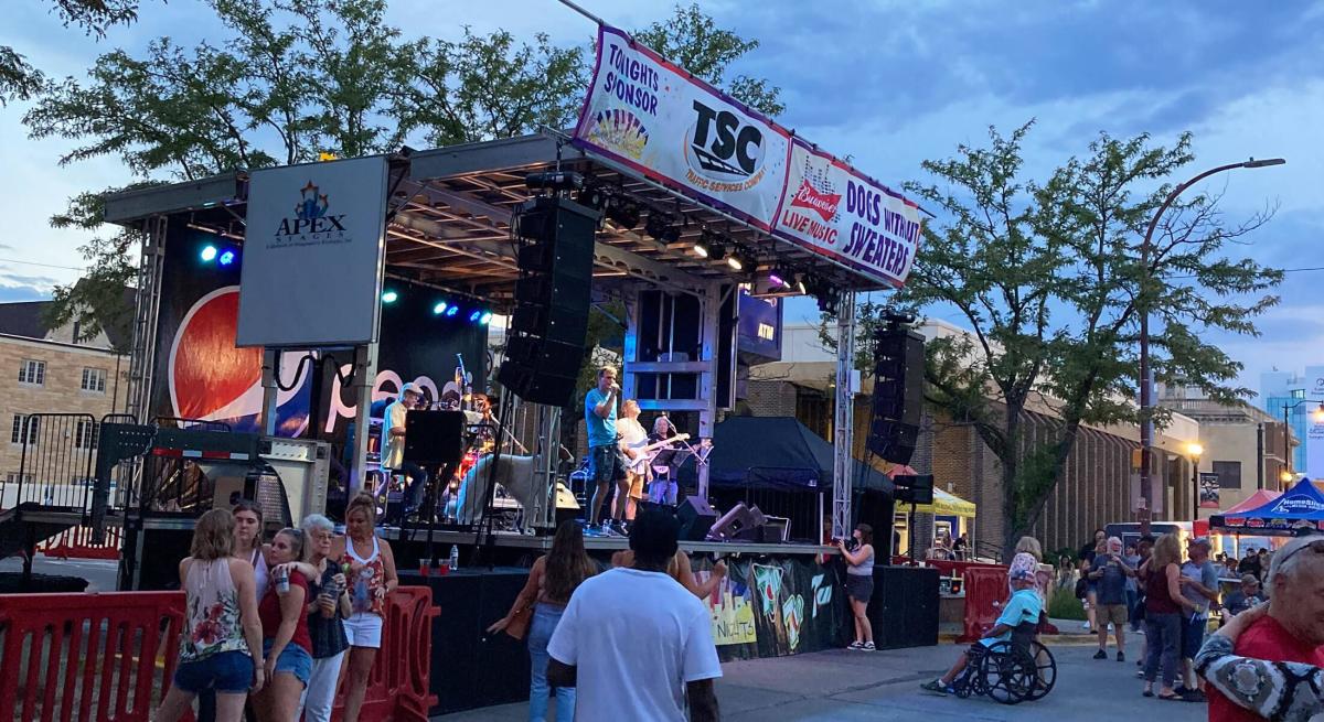 people dancing in front of the stage at summer nights event in rapid city sd