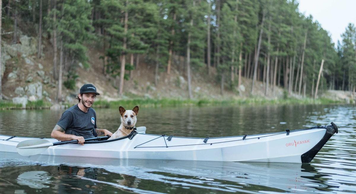Guy and dog in kayak at Sylvan Lake in Custer State Park