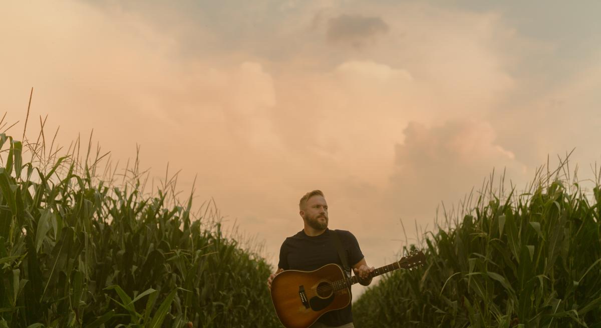 Country artist Logan Mize poses for a photo in a corn field