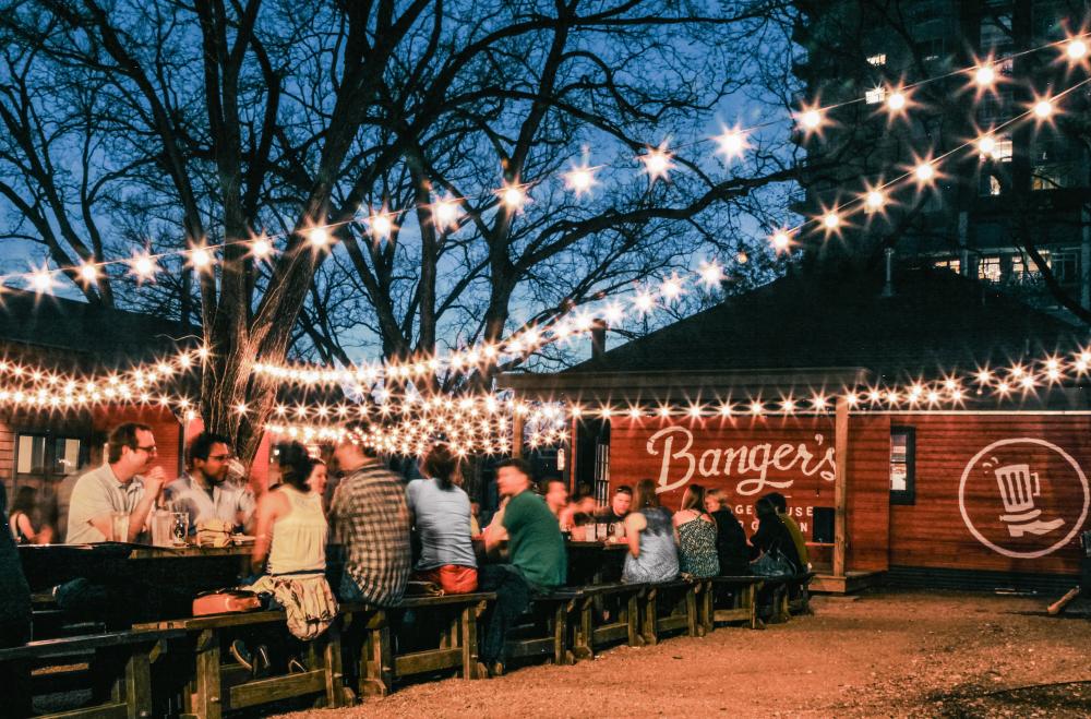 Patio lights illuminate the patio of Bangers Sausage House and Beer Garden at night