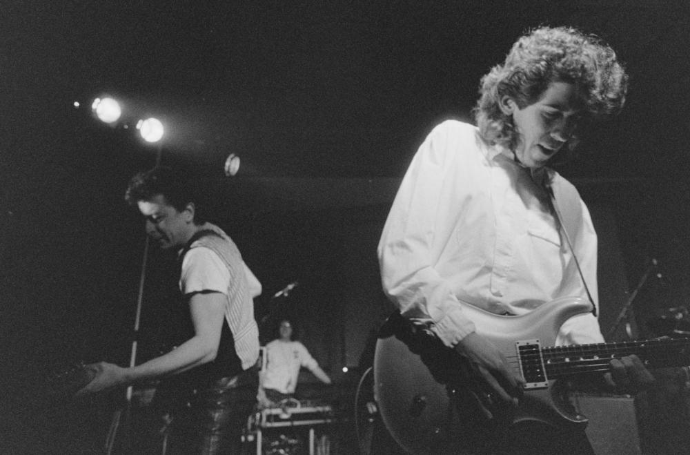 Black and white photo of Joe Ely playing the guitar at Crest Hotel