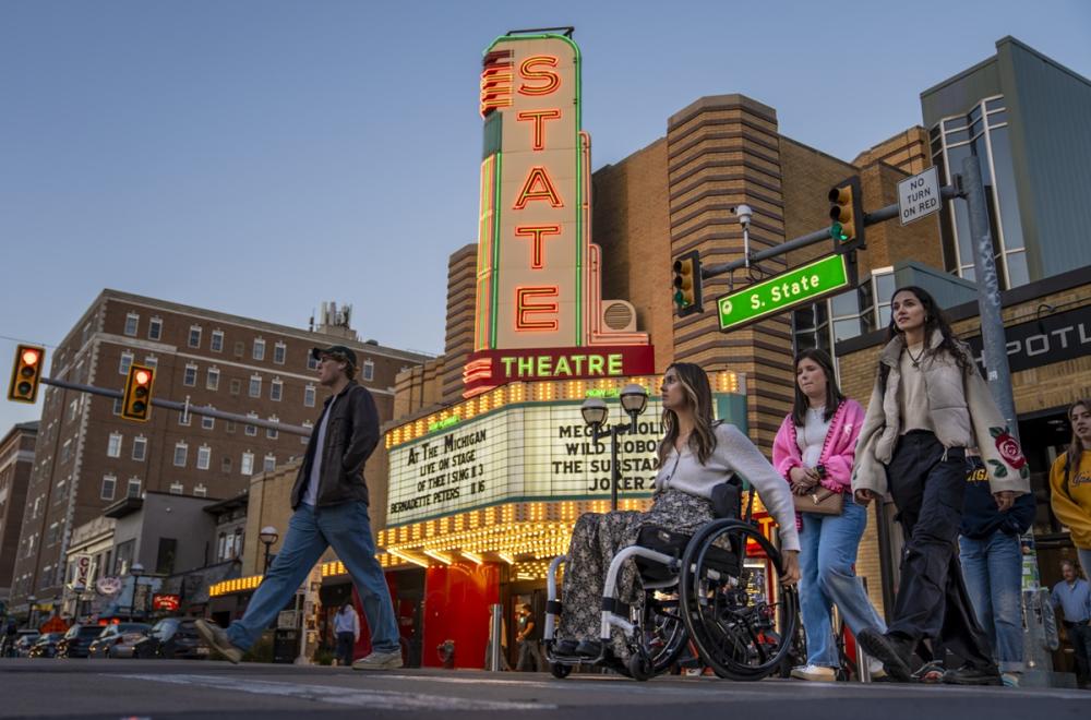 Friends crossing the street in front of State Theatre in Ann Arbor