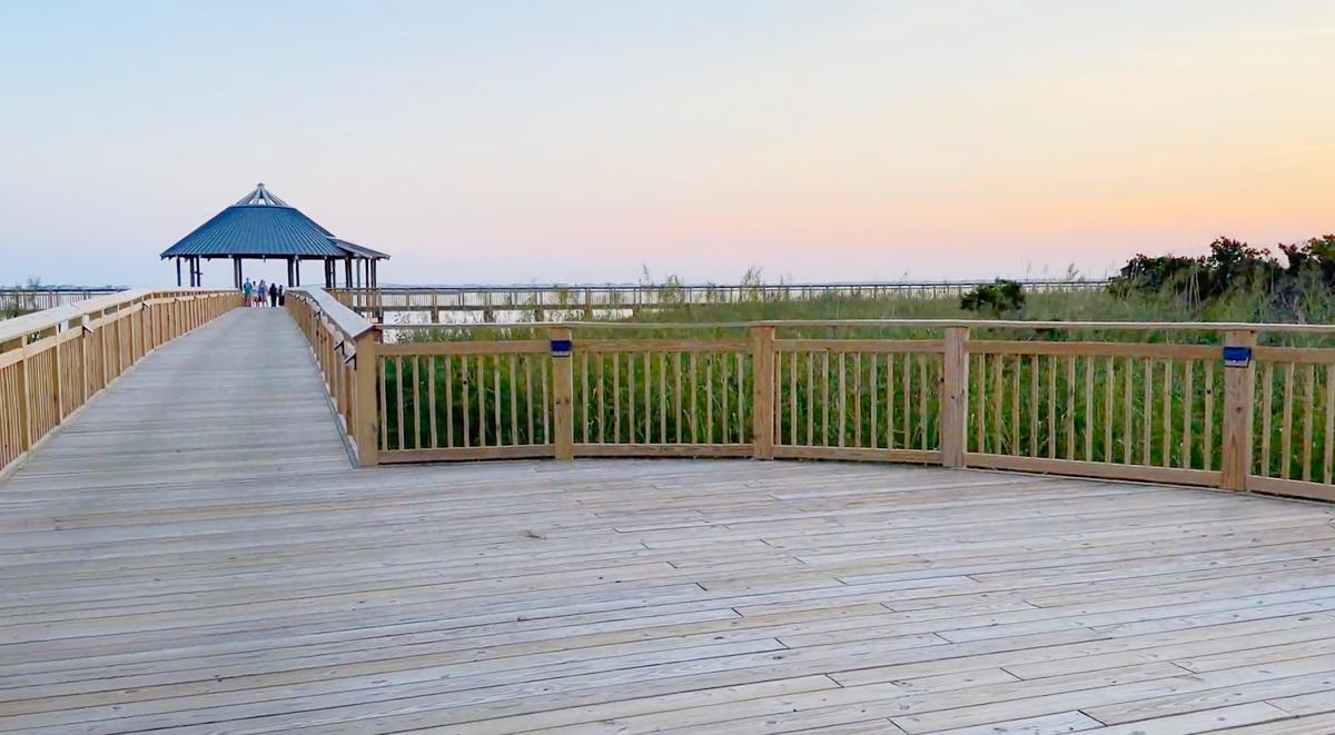 A golden sunset over the Roanoke Sound at The Soundside Boardwalk and Gazebo in Nags Head, NC.