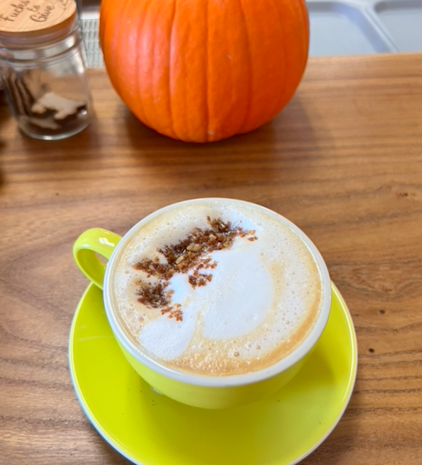 Cappuccino in a yellow mug on a yellow plate