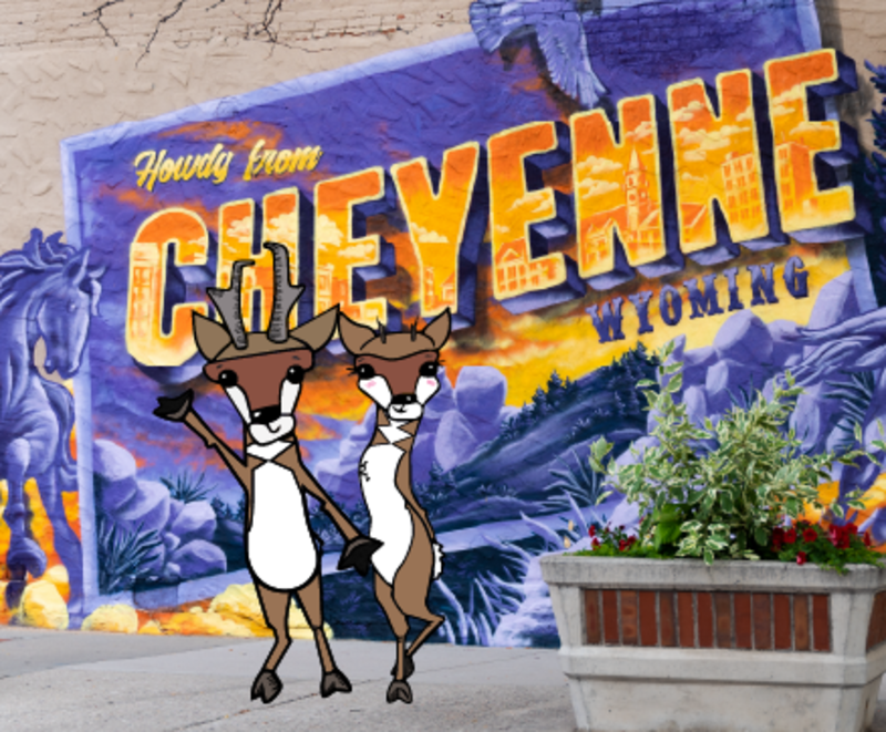 Two illustrated pronghorn antelope stand in front of the "Howdy from Cheyenne" mural in downtown Cheyenne.