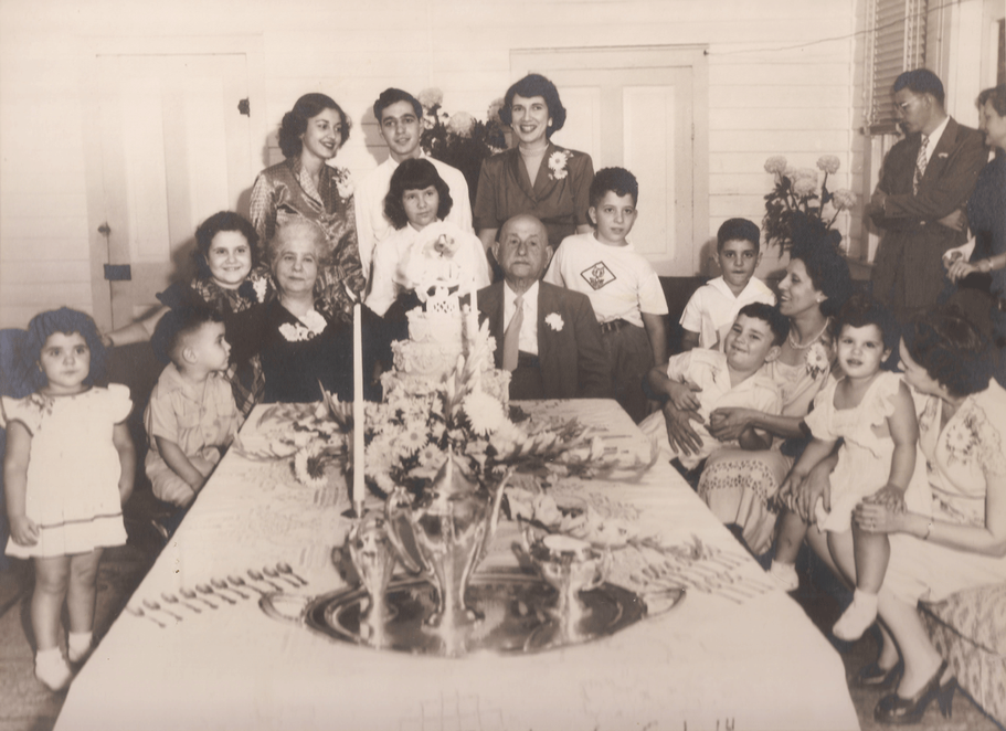 Mr. and Mrs. George Abdalla at a 1949 dinner celebrating their fiftieth wedding anniversary, surrounded by their grandchildren.
