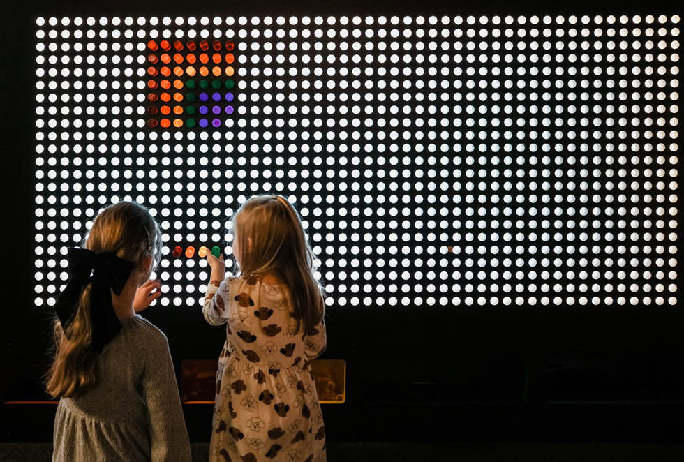 Two girls doing an interactive puzzle