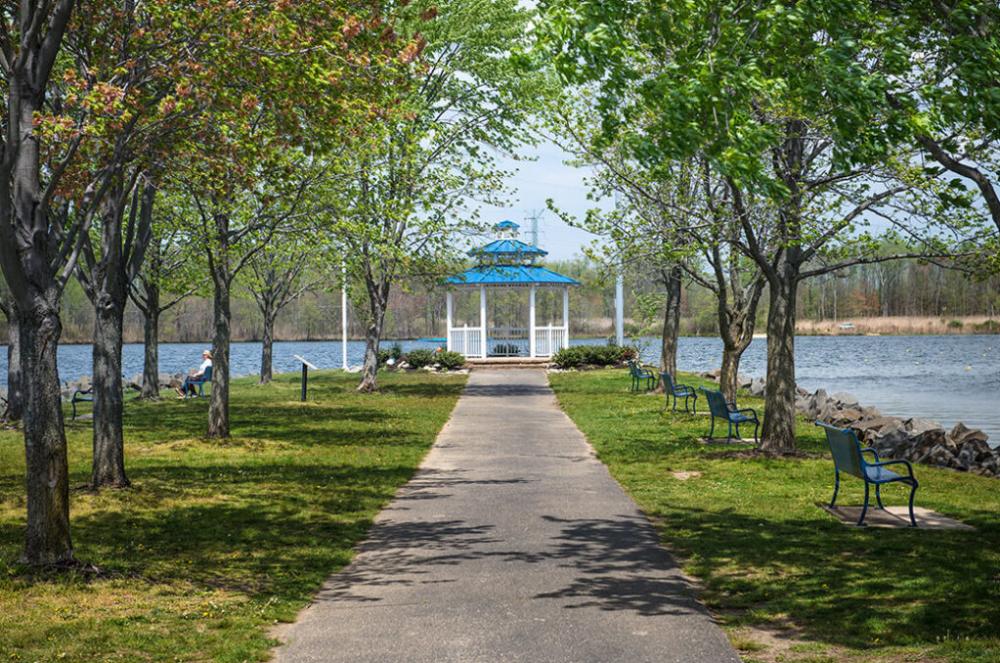 A view down a tree lined path that leads to the Mercer County Park Boathouse gazebo