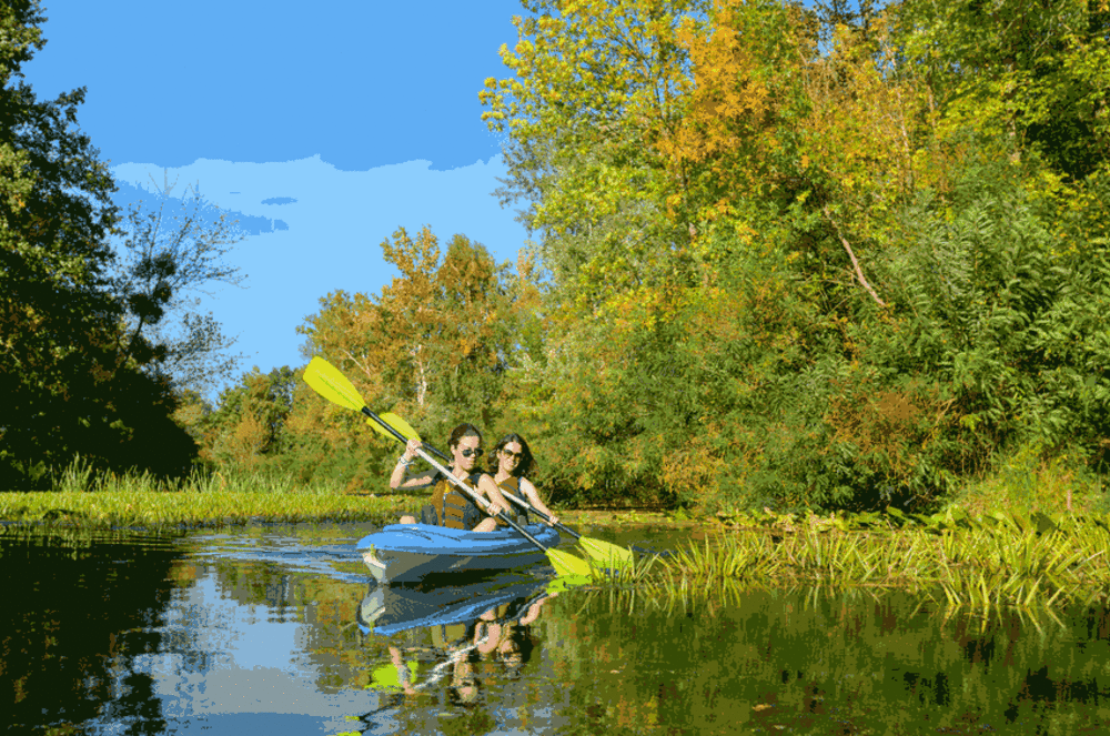 two women kayaking on millstone river near Princeton, NJ