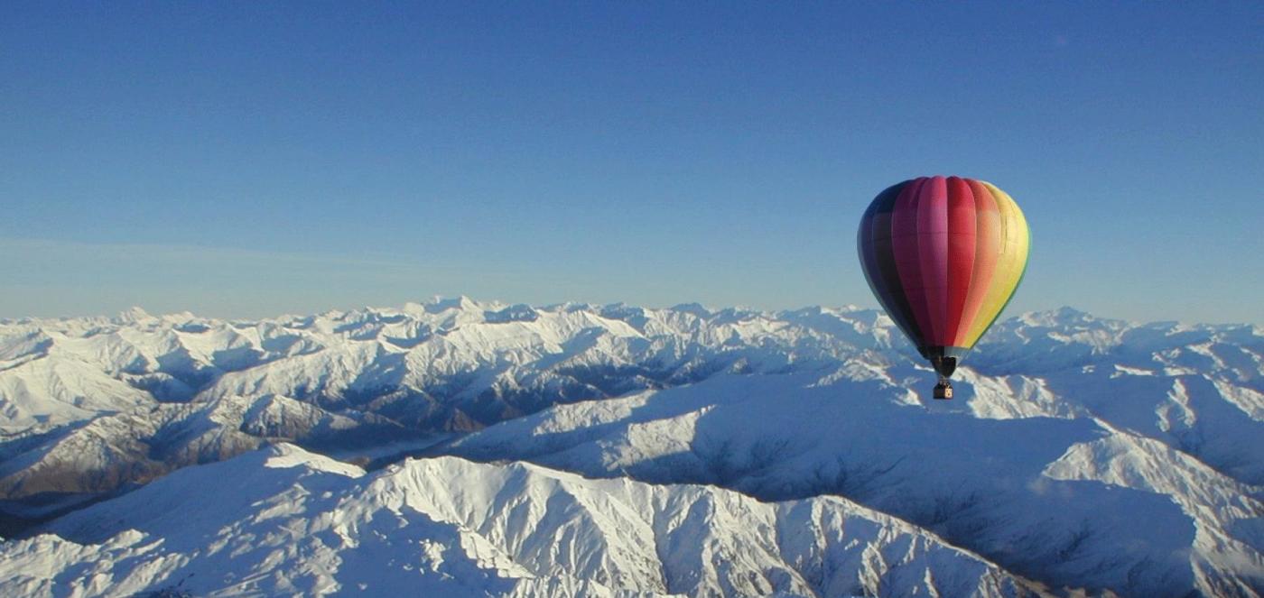 Hot Balloons Flight Over Mountains full of Snow