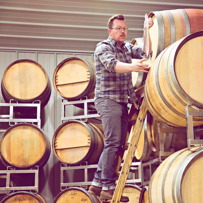 Winemaker and barrels.