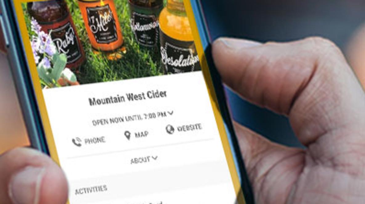 Hand holding phone with the Brew Pass on it
