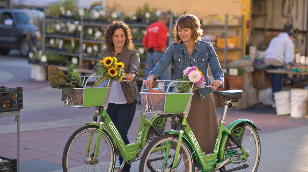 Women Riding GREENbikes with Flowers