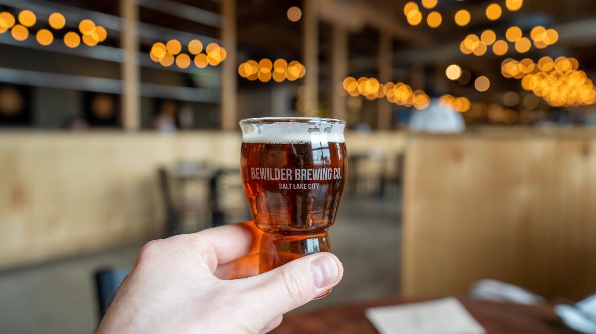 Hand holding a Bewilder beer