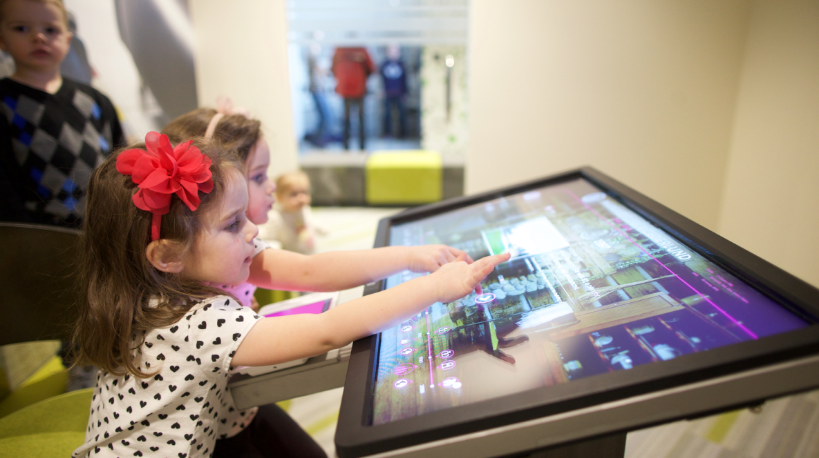 Two children explore the family's history in The Time Machine at the Family History Library in Salt Lake City, Utah.
