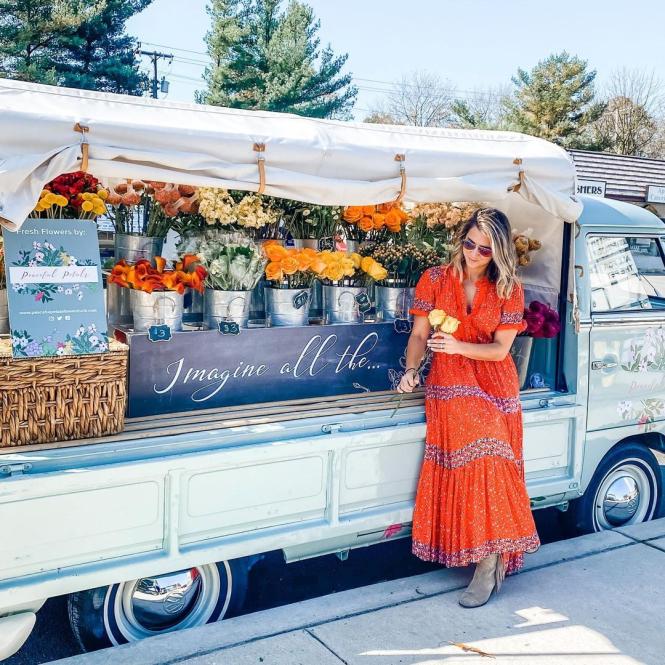 Megan Taylor stands with her VW converted Bus, JoJo the Peaceful Petals Flower Truck.